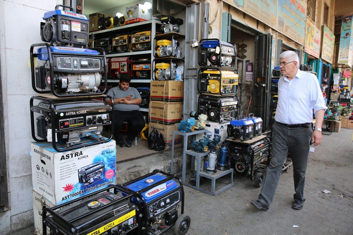 An Iraqi man shops at a store selling power generators in Baghdad on April 7, 2018. (SABAH ARAR/AFP via Getty Images)