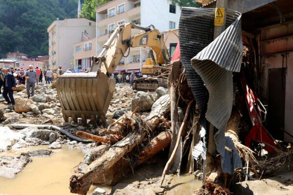 People inspect the destruction after floods caused by heavy rain in the mountain town of Dereli in Giresun province, along Turkey's Black Sea coastline, on Aug. 23, 2020. (AP Photo)