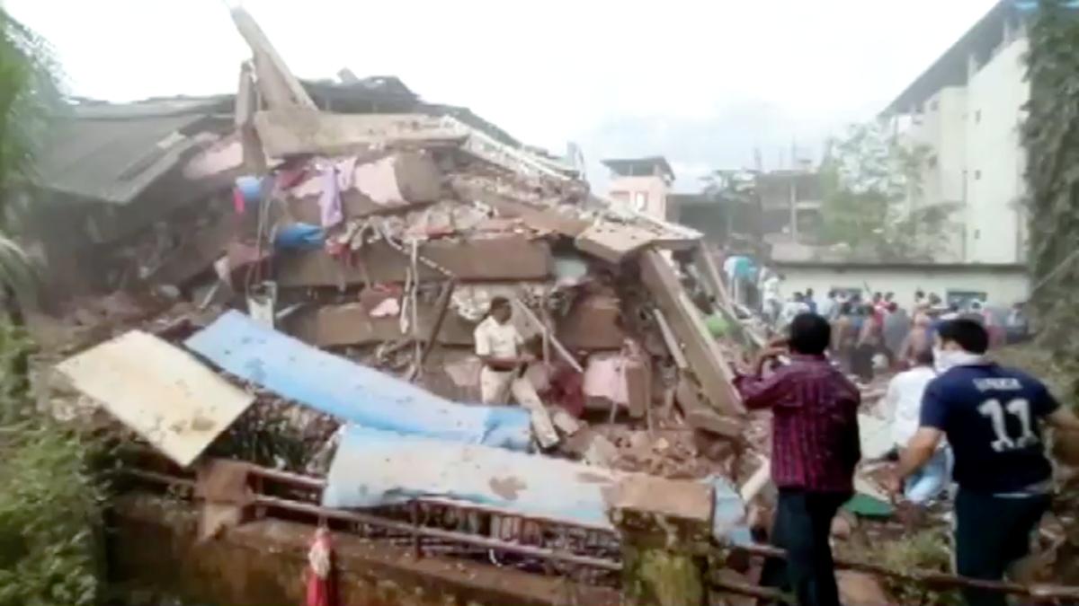 People are seen near the scene of a five-story building that collapsed in Raigad in the western state of Maharashtra, India, on Aug. 24, 2020. (ANI via Reuters)
