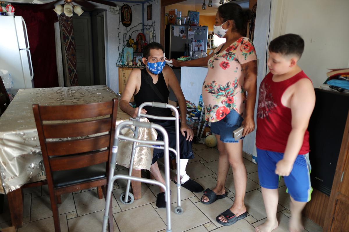 Francisco Garcia, 31, at his home with his sister Lorena Garcia, 33, and nephew Angel, 10, in Los Angeles, Calif., the United States, Aug. 19, 2020. (Lucy Nicholson/REUTERS)