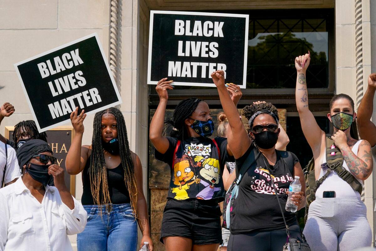 A group of Black Lives Matter protesters hold a rally on the steps of the Kenosha County Courthouse, which was closed because of damage inflicted by rioters just hours earlier, in Kenosha, Wis., on Aug. 24, 2020. (Morry Gash/AP Photo)
