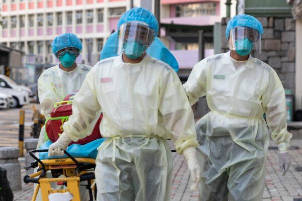 Medical staff wearing personal protective equipment as a precautionary measure against COVID-19 approach the Lei Muk Shue care home in Hong Kong, on Aug. 23, 2020. (May James/May James/AFP via Getty Images)