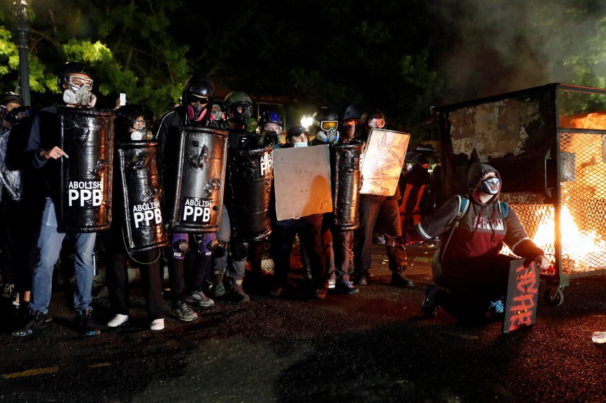 Demonstrators confront police during a riot in Portland, Ore., Aug. 23, 2020. (Terray Sylvester/Reuters)
