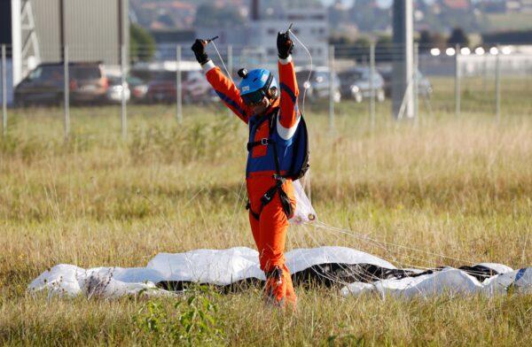 Project instigator Raphael Domjan reacts upon landing after he jumped with a parachute from the SolarStratos aircraft, a solar-powered two-seater aircraft, in Payerne, Switzerland, on Aug. 25, 2020. (Denis Balibouse via Reuters)