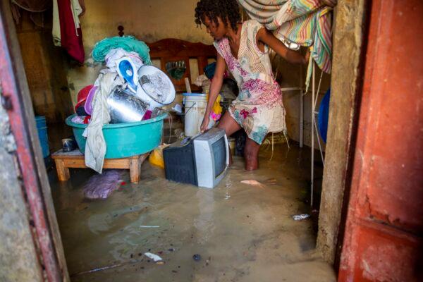 28-year old Lafaille Katia removes salvage items from her flooded house the day after the passing of Tropical Storm Laura in Port-au-Prince, Haiti, on Aug. 24, 2020. (Dieu Nalio Chery via AP Photo)
