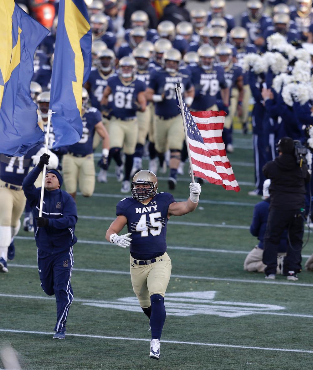 Quessenberry of Navy Midshipmen leads the team onto the field to play the Georgia Southern Eagles at the Navy-Marines Memorial Stadium in Annapolis, Maryland, on Nov. 15, 2014. (Chris Gardner/Getty Images)