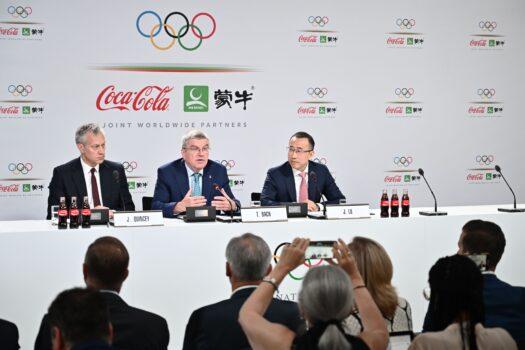 International Olympic Committee (IOC) president Thomas Bach (C), Coca-Cola President and CEO James Quincey (L) and China Mengniu Dairy CEO and Executive Director Jeffrey Minfang give a press conference during the 134th Session of the International Olympic Committee (IOC) at the SwissTech Convention Centre in Lausanne, on June 24, 2019. (Fabrice Coffrini/AFP via Getty Images)