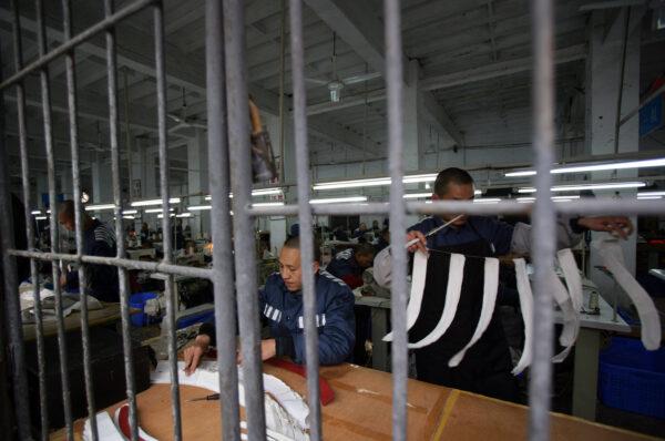 Inmates work in a sewing room at a prison on March 7, 2008 in Chongqing Municipality, China. (China Photos/Getty Images)