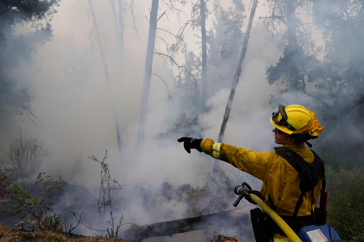 Firefighter Cody Nordstrom, of the North Central Fire station out of Kerman, Calif., monitors hot spots while fighting the CZU Lightning Complex Fire on Sunday, Aug. 23, 2020, in Bonny Doon, Calif. (Marcio Jose Sanchez/AP)