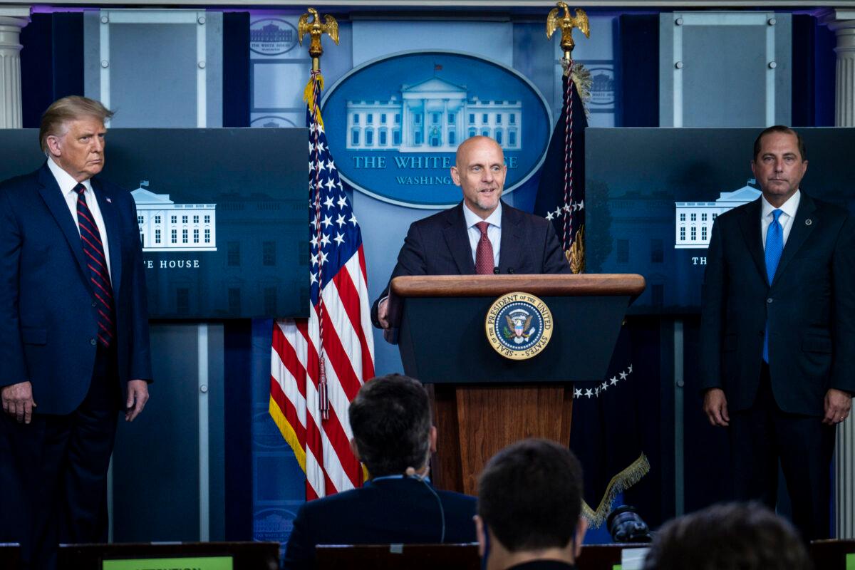 President Donald Trump and Health Secretary Alex Azar look on as FDA Commissioner Stephen Hahn addresses the media during a press conference in James S. Brady Briefing Room at the White House in Washington on Aug. 23, 2020. (Pete Marovich/Getty Images)