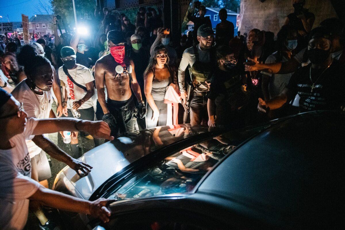 Demonstrators stop a car on a street in Kenosha, Wis, Aug. 24, 2020. (Brendon Bell/Getty Images)