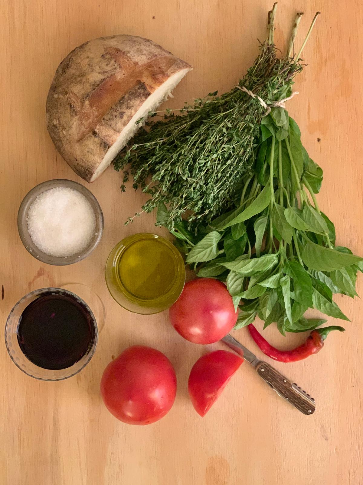 Prep your ingredients: summer tomatoes, rustic country bread, fresh herbs, olive oil, salt, and red wine. (Kate Korol)