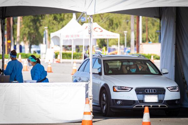 A driver waits to be tested for COVID-19 at a new testing super site at the Orange County Fair and Event Center in Costa Mesa, Calif., on Aug. 26, 2020. (John Fredricks/The Epoch Times)