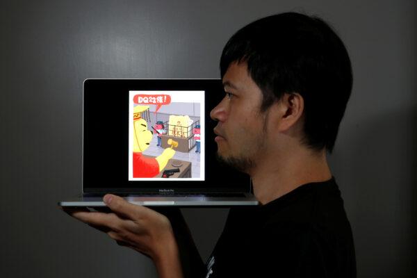 Political illustrator Ah To poses with his cartoon after his column in one of the city's popular news magazines will get axed in Hong Kong, China, on July 28, 2020. (Tyrone Siu/Reuters)