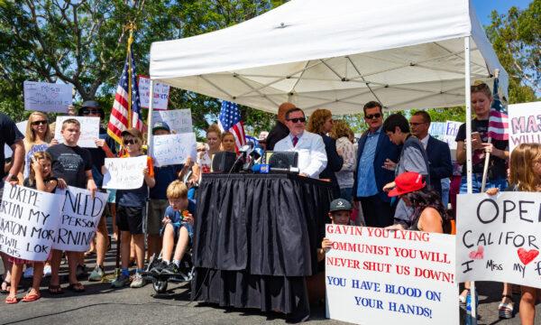 Citizens gather at a protest supporting a lawsuit calling for the immediate reopening of schools in front of the Orange County Department of Education building in Costa Mesa, Calif., on Aug. 26, 2020. (John Fredricks/The Epoch Times)