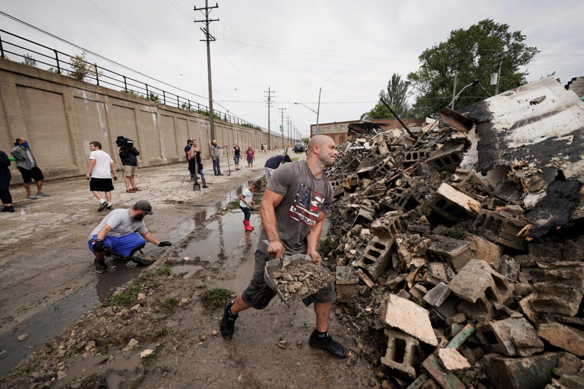Volunteers clean up the Kenosha County Department of Corrections building after it was burned to the ground during rioting in Kenosha, Wis., Aug. 25, 2020. (Morry Gash/AP Photo)