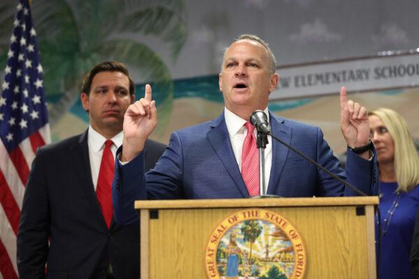 Florida Gov. Ron DeSantis (L) listens as Florida Education Commissioner Richard Corcoran speaks during a press conference at Bayview Elementary School in Fort Lauderdale, Florida, on Oct. 7, 2019. (Joe Raedle/Getty Images)