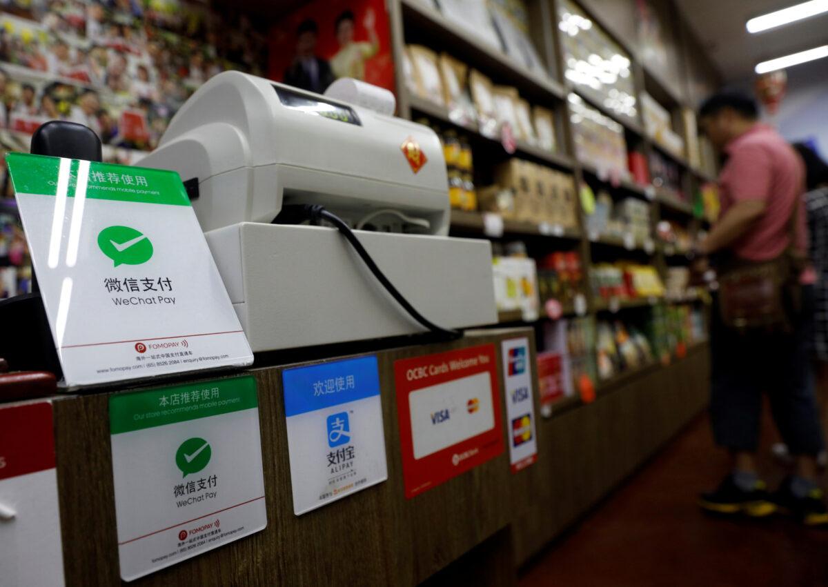 Signs accepting WeChat Pay and AliPay are displayed at a shop in Singapore on May 22, 2018. (Edgar Su/Reuters)