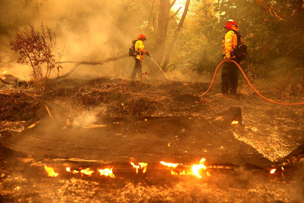 Pacific Gas and Electric firefighters extinguish spot fires as the LNU Lightning Complex fire hits Fairfield, Calif., on Aug. 19, 2020. (Justin Sullivan/Getty Images)