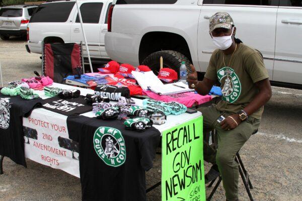 A stand selling merchandise is set up outside of the Freedom Protest Rally at Riley's Farm in Oak Glen, Calif., on Aug. 15, 2020. (Brad Jones/The Epoch Times)