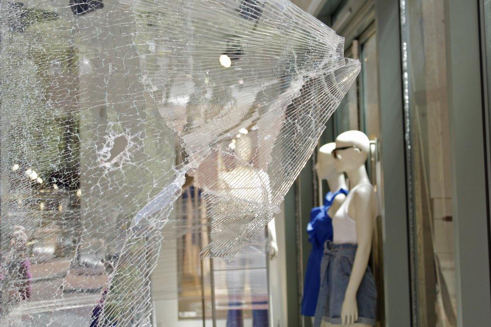 Mannequins are seen through shattered glass at an H&M store in downtown Portland, Ore., on July 13, 2020. (Gillian Flacus/AP Photo)