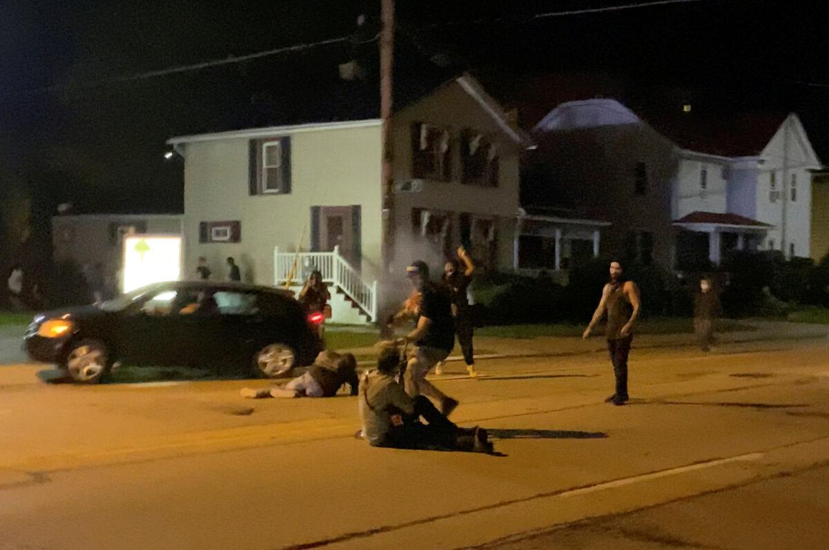 In this still image obtained from a social media video, a man is shot in his arm during unrest in Kenosha, Wis., on Aug. 25, 2020. (Brendan Gutenschwager/via Reuters)