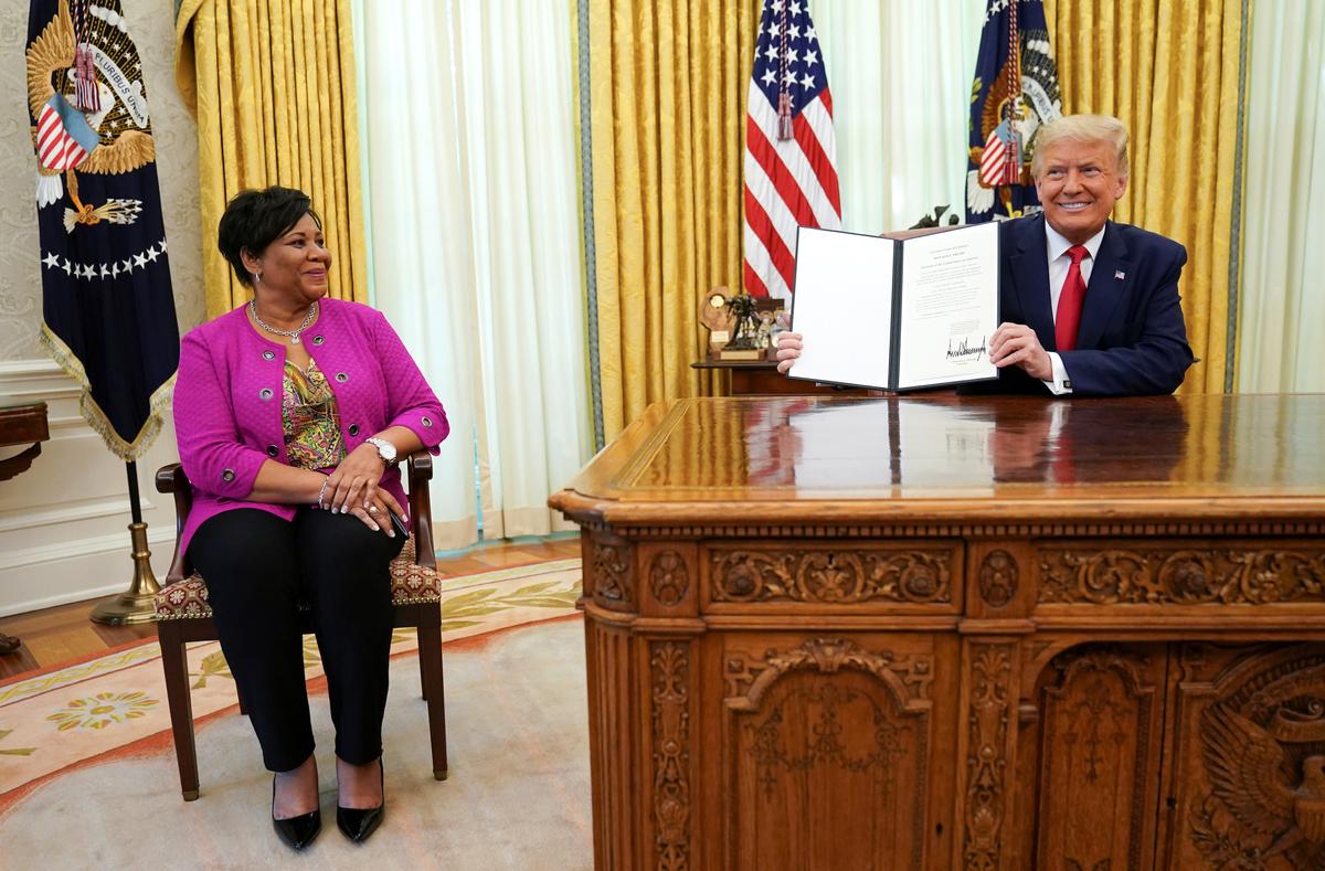 Alice Johnson, who received a life sentence for a first-time drug offense, receives a pardon from President Donald Trump in the Oval Office of the White House in Washington, on Aug. 28, 2020. (Kevin Lamarque/Reuters)