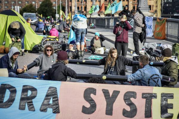 Climate change activists of Extinction Rebellion block the traffic at a bridge in central Stockholm on Aug. 28, 2020. (TT News Agency/Lars Schroder via Reuters)