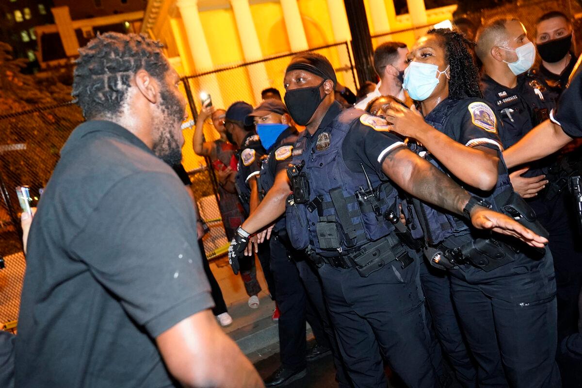 Metropolitan Police are confronted by protestors in Washington, on Aug. 27, 2020. (Julio Cortez/AP Photo)