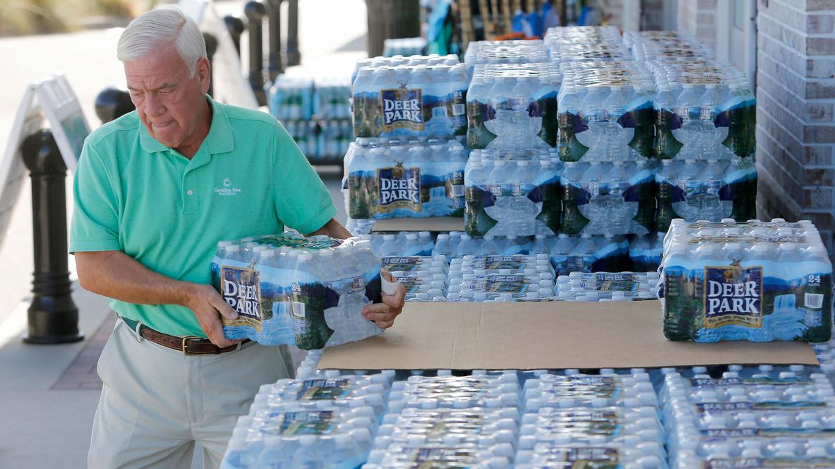 Larry Pierson, from the Isle of Palms, S.C., purchases bottled water from a Harris Teeter grocery store in preparation for Hurricane Florence at the Isle of Palms, S.C., Monday, Sept. 10, 2018. (Mic Smith/AP)