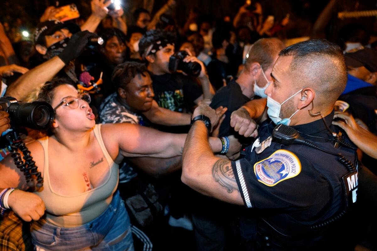 Demonstrators clash with police officers in Washington on Aug. 27, 2020. (Julio Cortez/AP Photo)