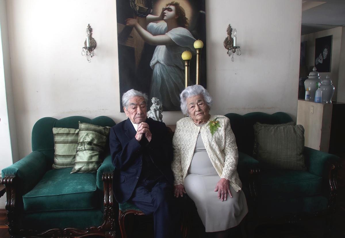 Julio Cesar Mora Tapia, 110 years old and his wife, Waldramina Maclovia Quinteros Reyes, 104 years old, at their house, in Quito, Ecuador, Friday, Aug. 28, 2020. (Dolores Ochoa/AP)