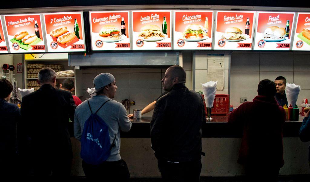 People wait for their orders at a fast-food stand in downtown Santiago, Chile, on Oct. 16, 2018. The nutritional prospect of the Chilean population is "critical" due to its high levels of obesity and the increase in undernourishment, the UN Food and Agriculture Organization stated. (Martin Bernetti/AFP via Getty Images)