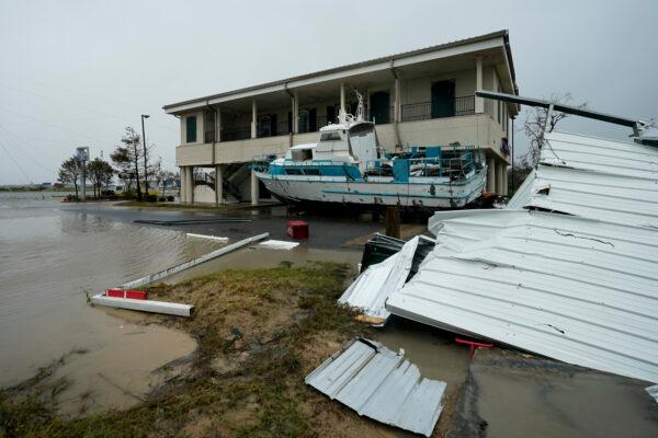 Flooding surrounds a damaged building and boat on Aug. 28, 2020, in Cameron, La., after Hurricane Laura moved through the area Thursday. (David J. Phillip/AP Photo)