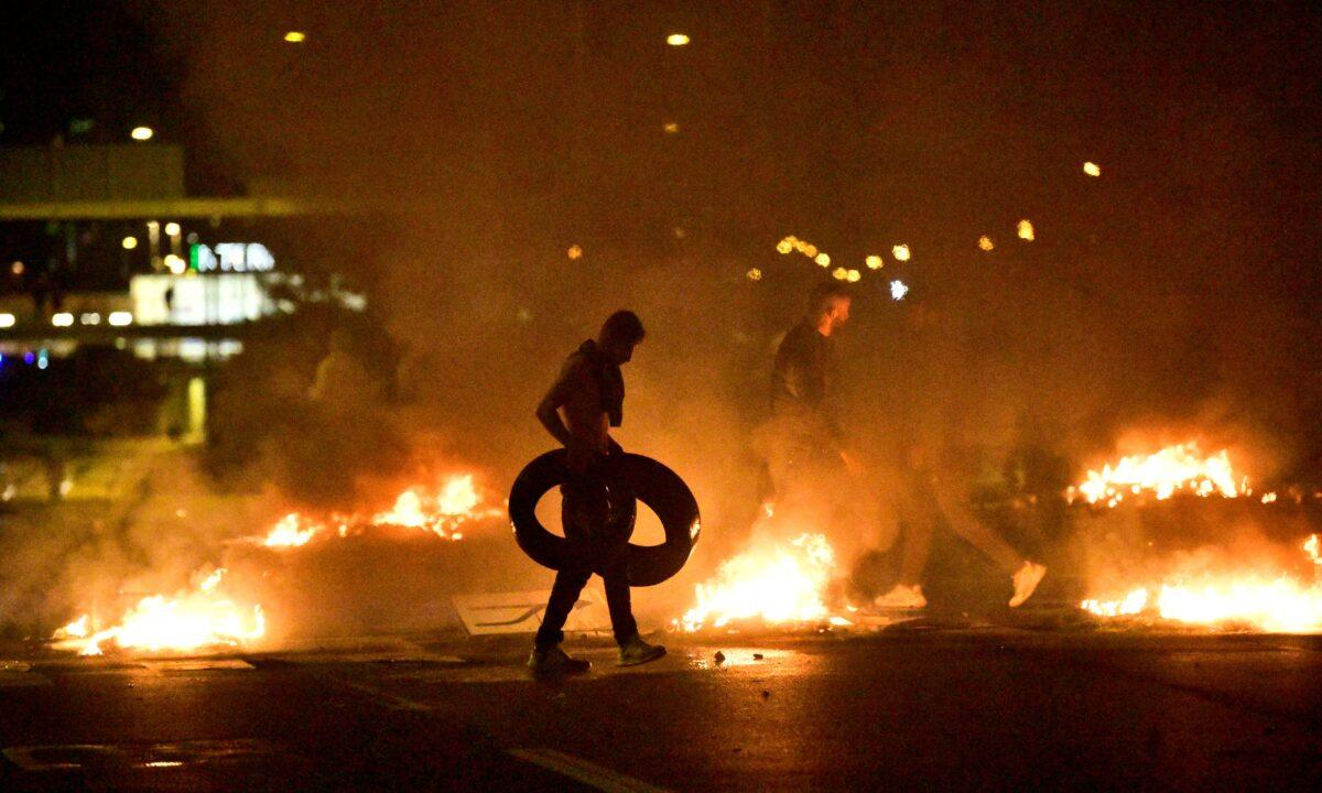 Demonstrators burn tyres during a riot in the Rosengard neighborhood of Malmo, Sweden, on Aug. 28, 2020. (TT News Agency via Reuters)