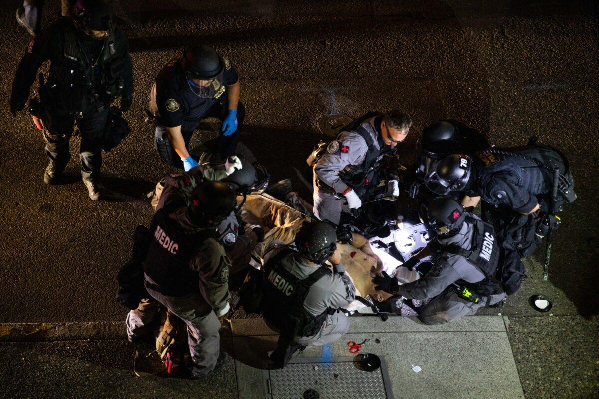 A man is treated after being shot in Portland, Ore., on Aug. 29, 2020. He died from his wounds. (Paula Bronstein/AP Photo)