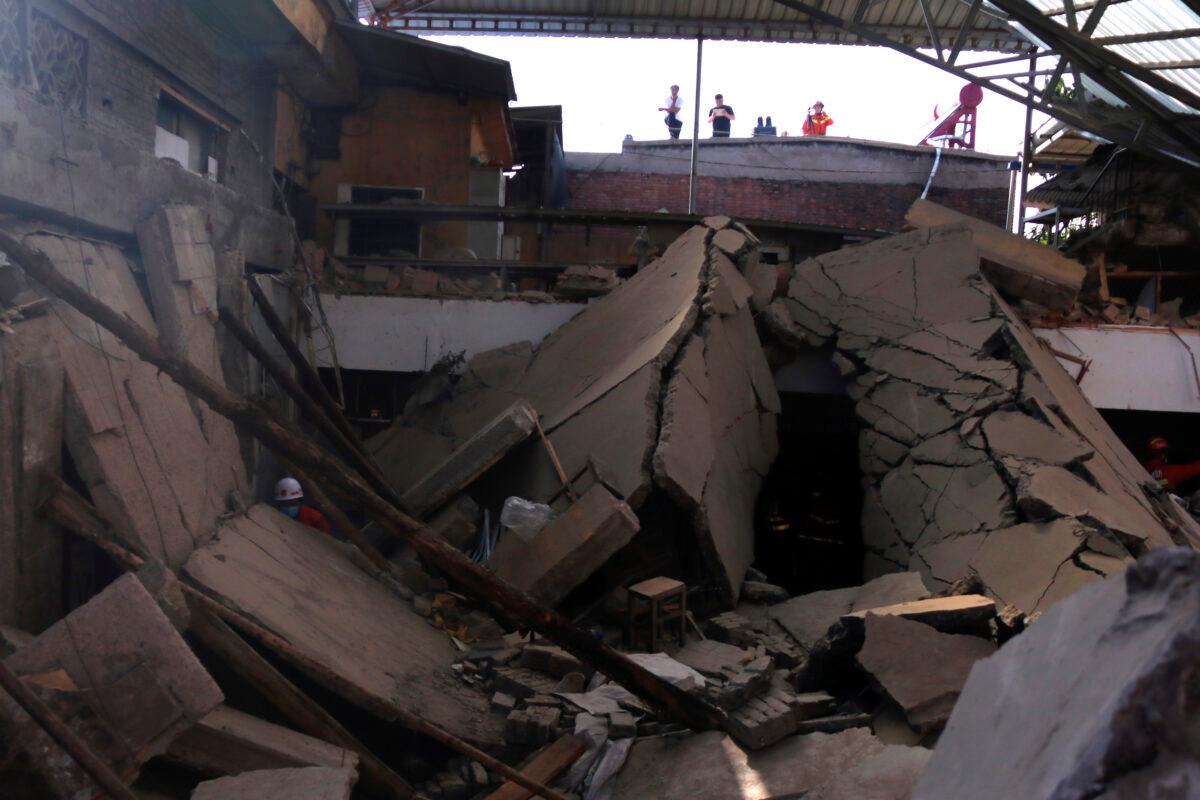 Rescuers search for victims in the aftermath of the collapse of a two-story restaurant in Xiangfen county in northern China's Shanxi province on Aug. 29, 2020. (Chinatopix Via AP)