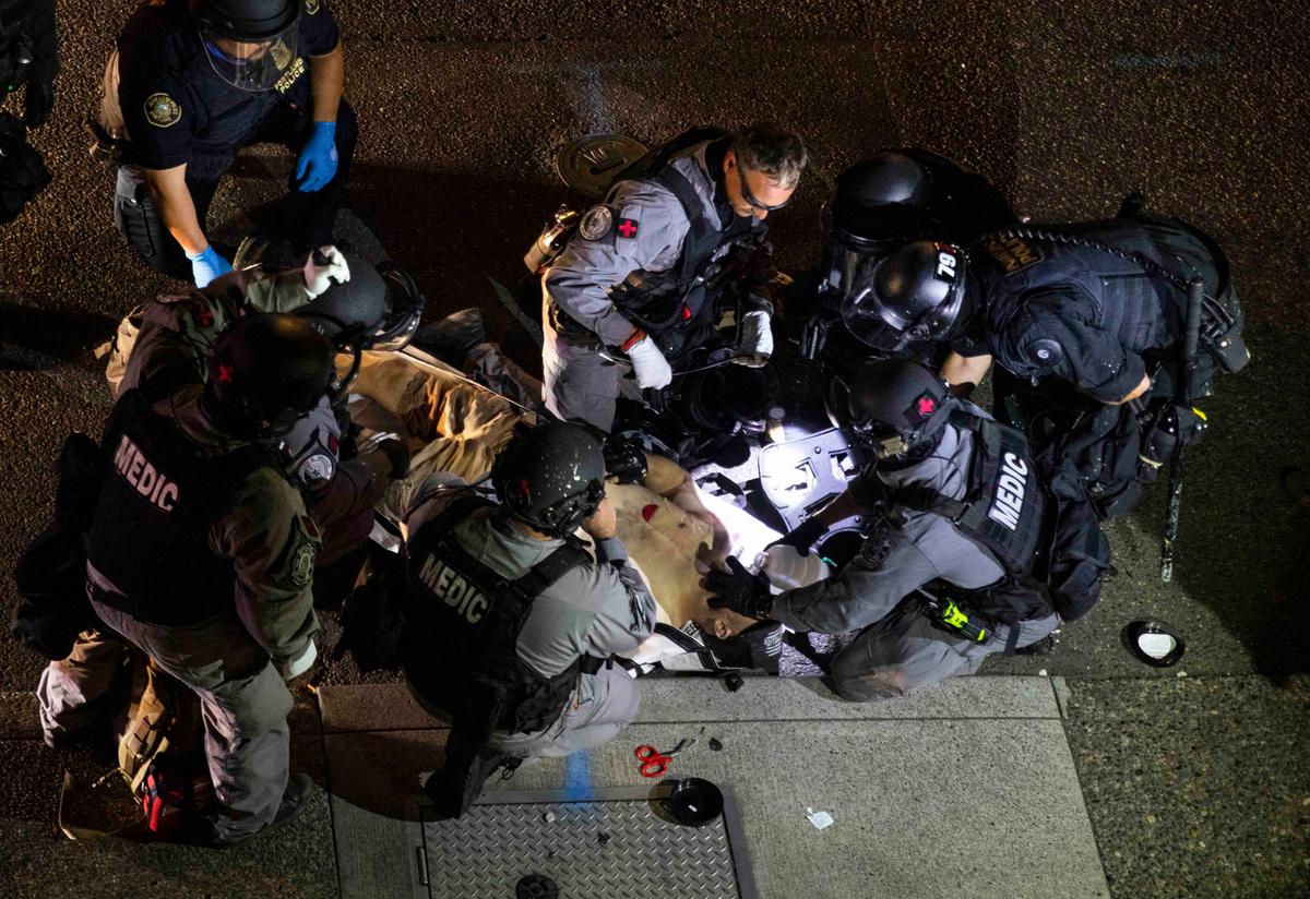 A man is treated by medics after being shot during a confrontation in Portland, Ore,, on Aug. 29, 2020. (Paula Bronstein/AP Photo)