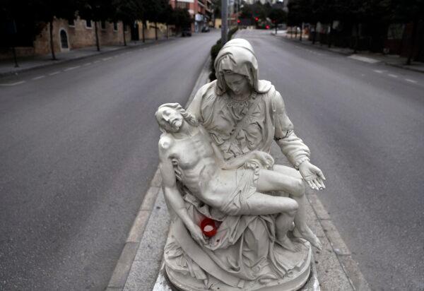 A statue representing Virgin Mary and Jesus is seen in the middle of an empty highway as part of the preventive measures against the ongoing coronavirus pandemic in Beirut, Lebanon, on March 30, 2020. (Hussein Malla/AP Photo)