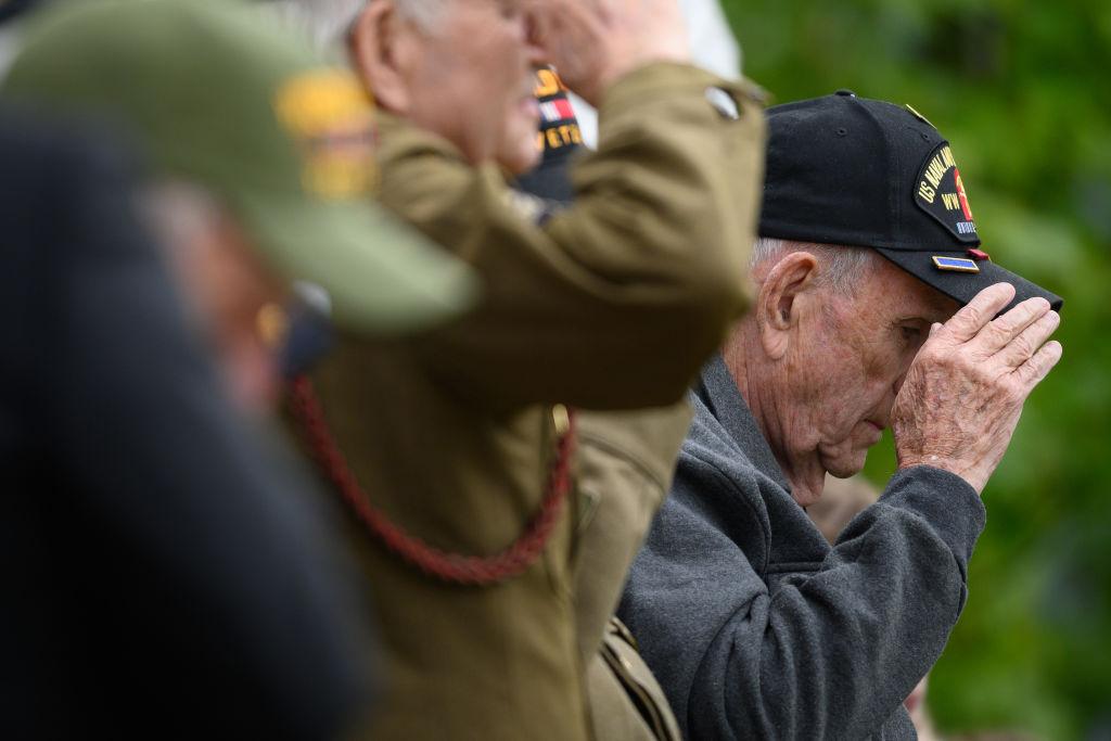World War II veterans stand to salute during a ceremony marking the 75th anniversary of the D-Day landings in Carentan, France, on June 5, 2019 (Leon Neal/Getty Images)