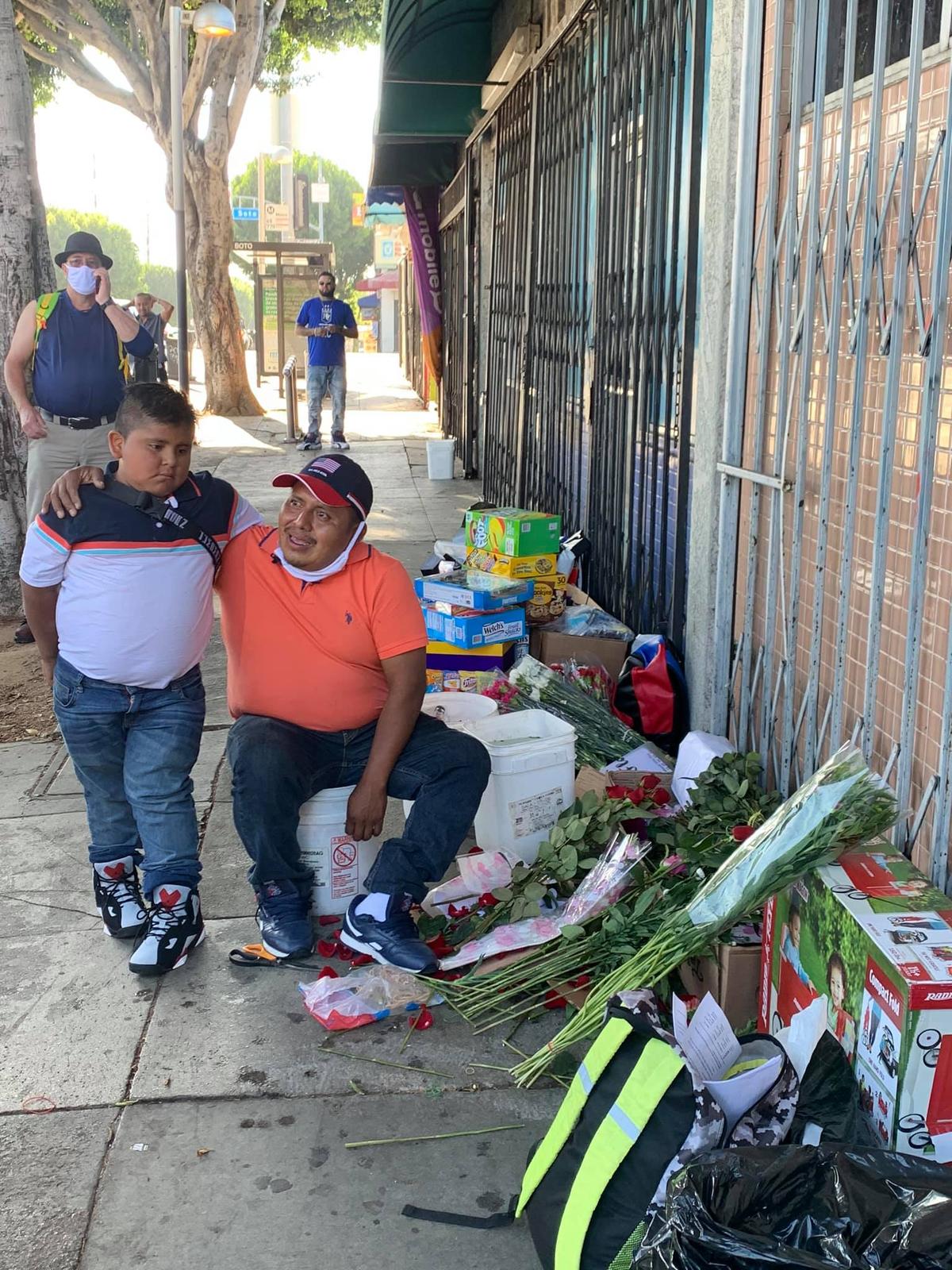Edgar and his father selling flowers on the street. (Courtesy of <a href="https://www.facebook.com/erik.luevanos/posts/3152694684820443">Erik Luevanos</a>)