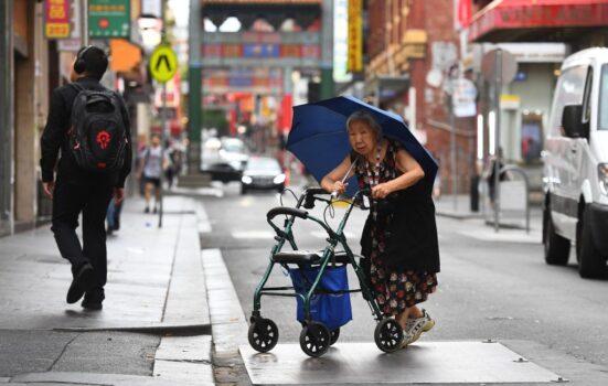 A lady crossing the street in Melbourne's Chinatown on Feb. 14, 2020. (William West/AFP via Getty Images)