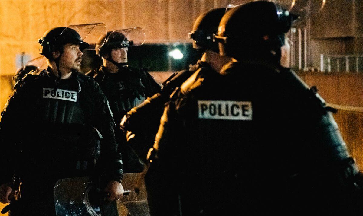 Police officers stand guard inside of a fenced area that surrounds several government buildings in Kenosha, Wis., on Aug. 27, 2020. (Brandon Bell/Getty Images)