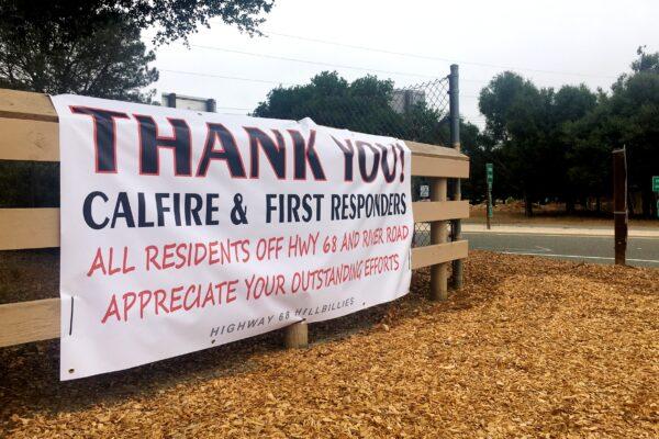 A sign next to Route 68 to Carmel Valley, Calif., shows support for firefighters on Aug. 26, 2020. (Ilene Eng/The Epoch Times)