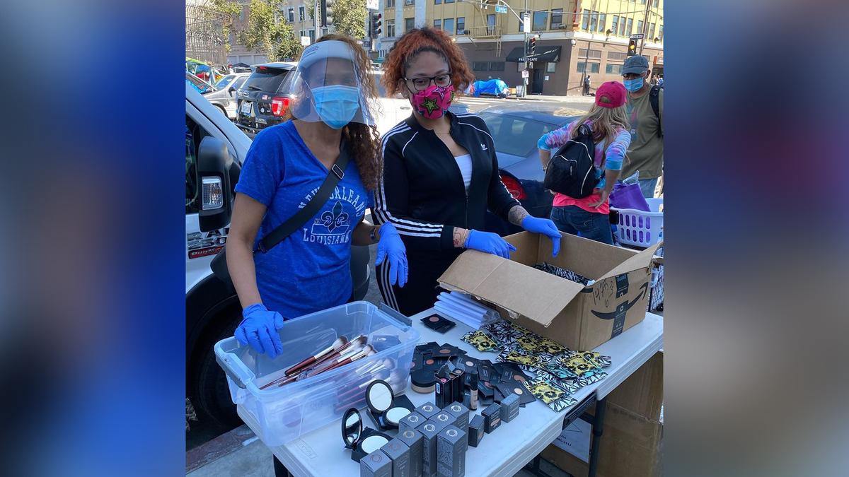 Volunteers Coco and Happiness handing out makeup to Skid Row's residents earlier this August. (Courtesy of Shirley Raines)
