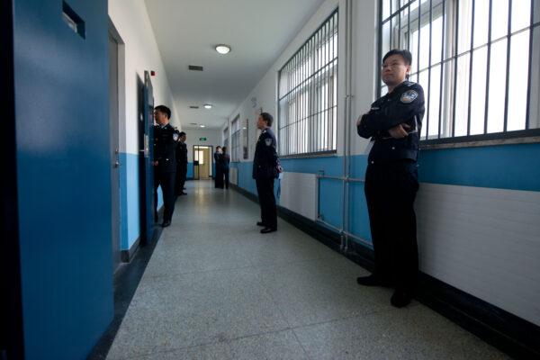 Police guards stand in a hallway inside the No.1 Detention Center during a government guided tour in Beijing on Oct. 25, 2012. (Ed Jones/AFP via Getty Images)