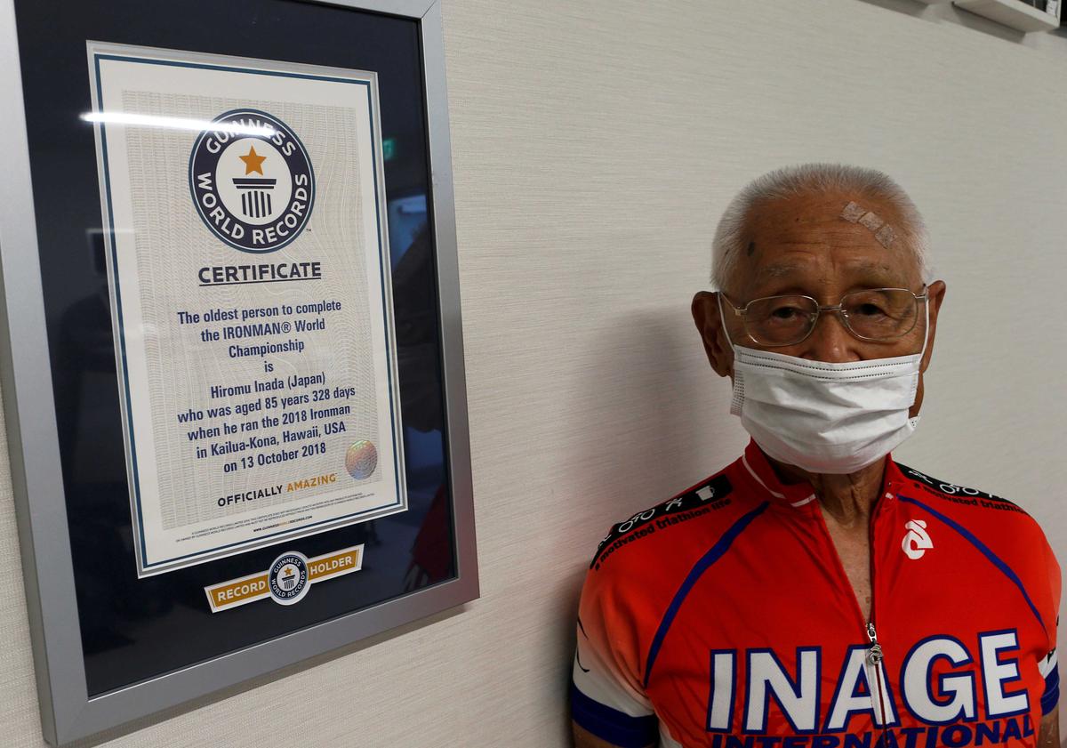 Hiromu Inada poses for a photograph next to his certificate from Guinness World Record at his training facility in Chiba, near Tokyo, Japan, Aug. 26, 2020. (Jack Tarrant/REUTERS)