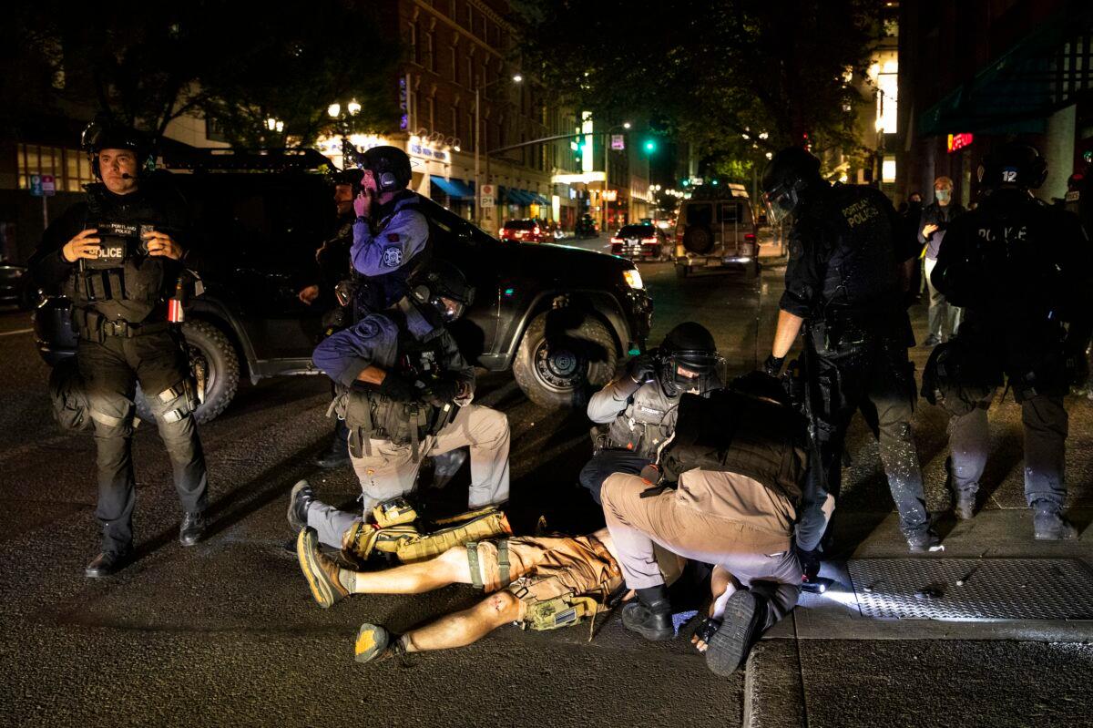 A man shot in Portland, Ore., is treated on Aug. 29, 2020. The man later died. (Paula Bronstein/AP Photo)