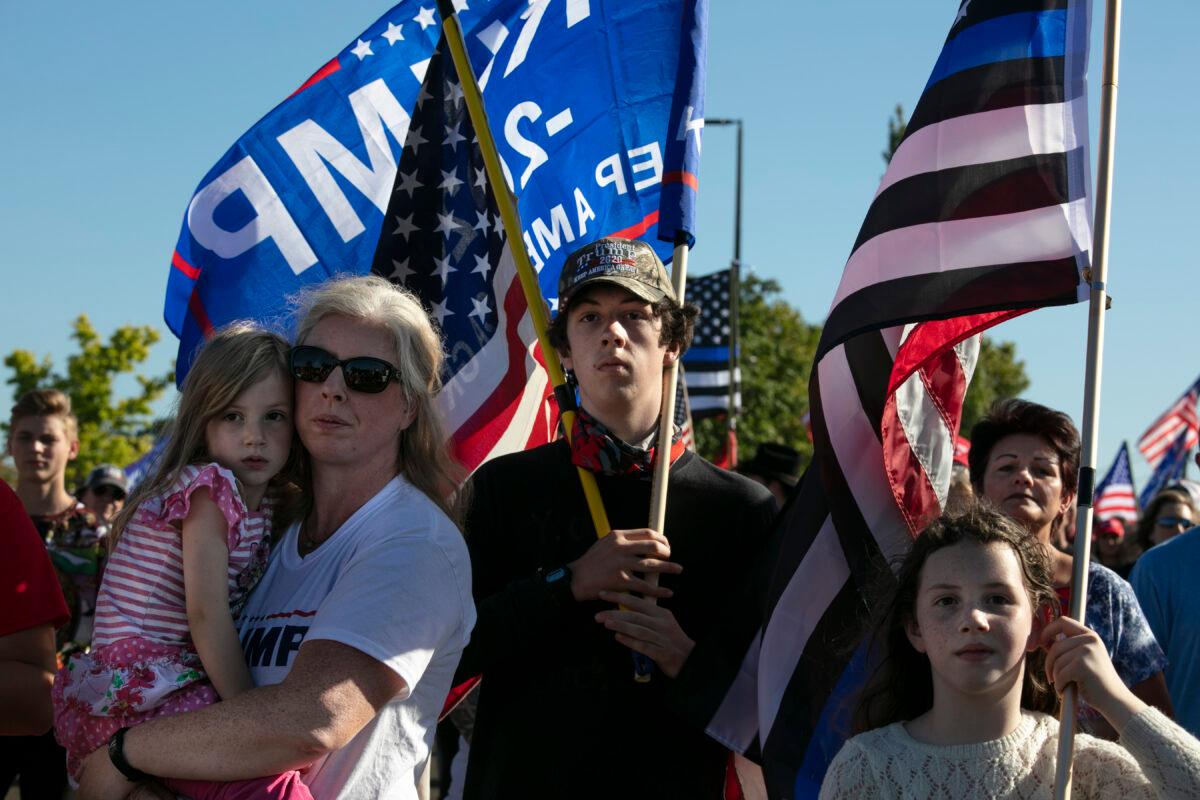 Supporters of President Donald Trump listen to speeches at a rally before a car parade into Portland, in Clackamas, Ore., Aug. 29, 2020. (Paula Bronstein/AP Photo)