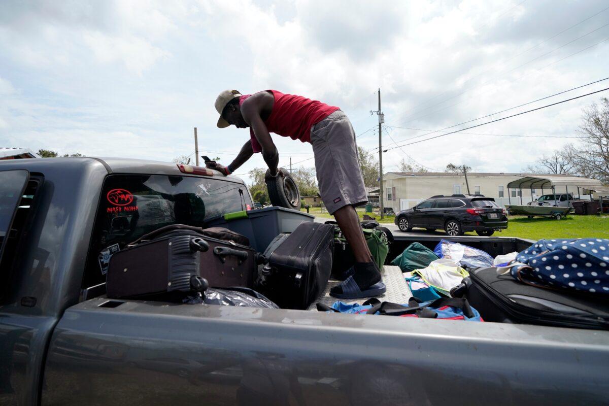 Bernie Murray rearranges luggage in Lake Charles, La., on Aug. 30, 2020. (Gerald Herbert/AP Photo)